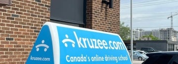 Kruzee sign stuck on top of a car