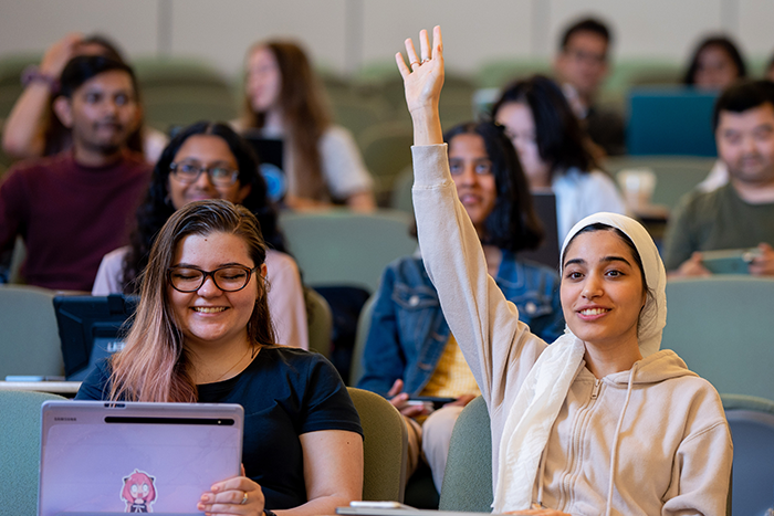 A student puts her hand up in class