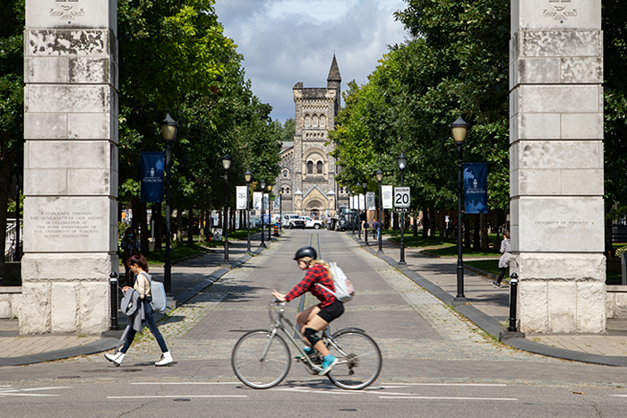 A cyclist rides by St. George campus