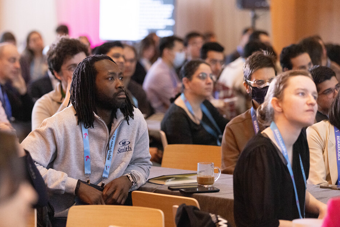 A room full of people seated at a conference