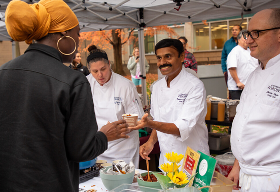 A person is served lunch by the catering staff