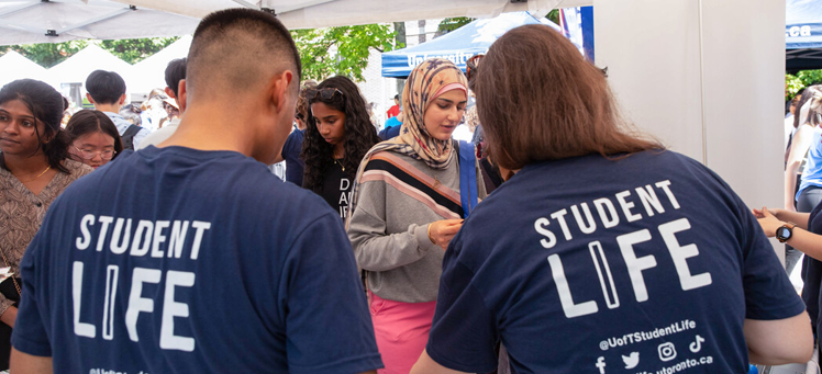 Two people with their backs to the camera wearing blue shirts