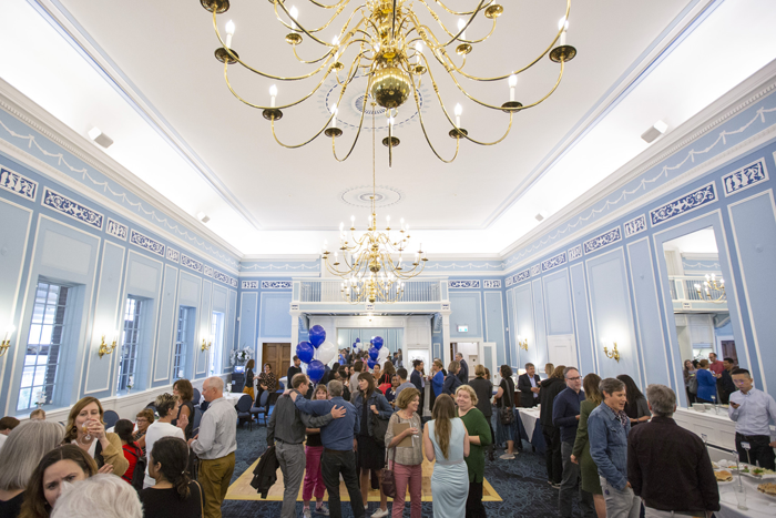 A large group gathers at The Faculty Club