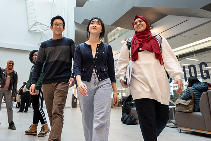 Three students walk together at UTSC