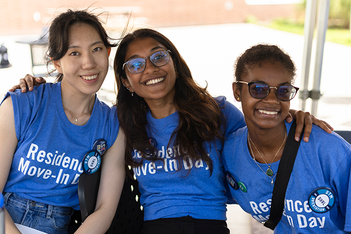 Three people in blue shirts