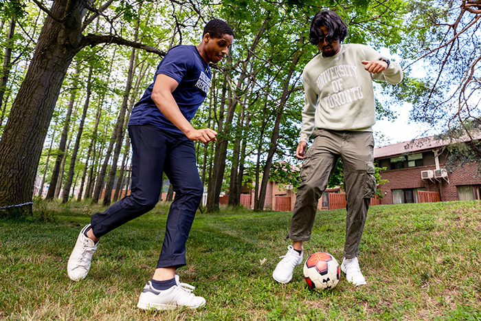 Two people play soccer together