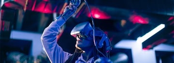 Woman uses a VR system in a darkened room