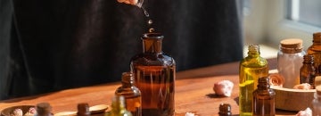 a person mixes various liquid ingredients into a bottle