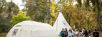 People gather outisde the teaching lodge at UTM