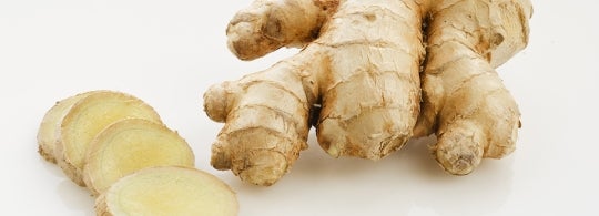 A photo of sliced ginger and ginger root