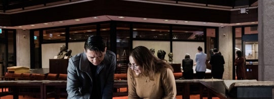 Two students examine a book in U of T's Fisher Rare Book Library