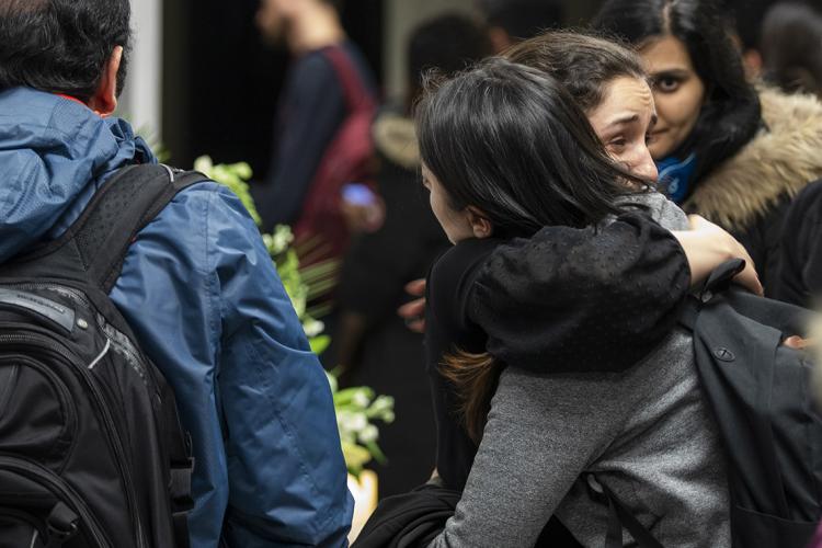 Two women embrace at the vigil for the U of T victims of the ukranian air plane crash