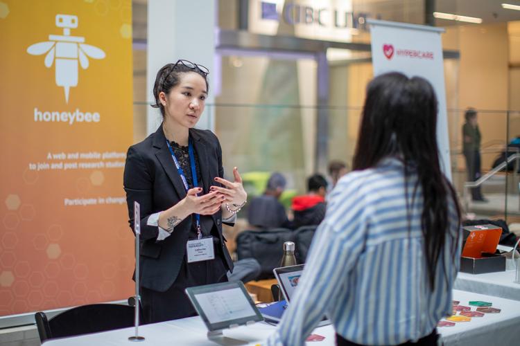 Catherine Chan speaks to an attendee of the true blue expo at the Mars discovery district