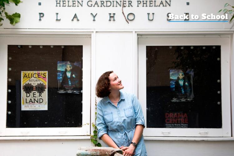 Marie Trotter sitting on a bench outside the Helen Gardener Phelan Playhouse