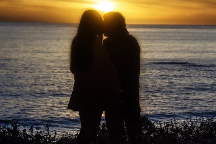 photo of a couple embracing by the water