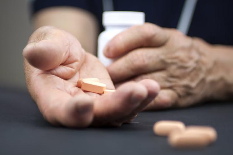 Photo of man holding drugs