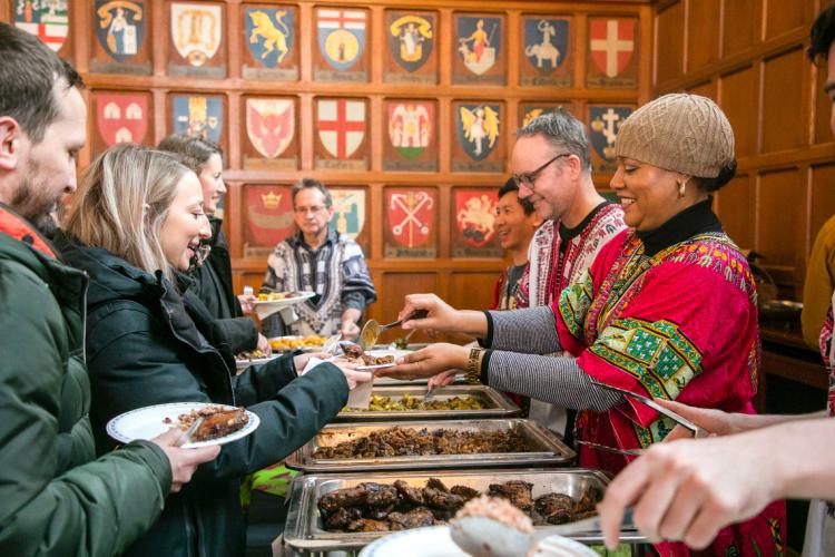 A volunteer serves food to attendees at the Black History Month Luncheon at Hart House in 2020