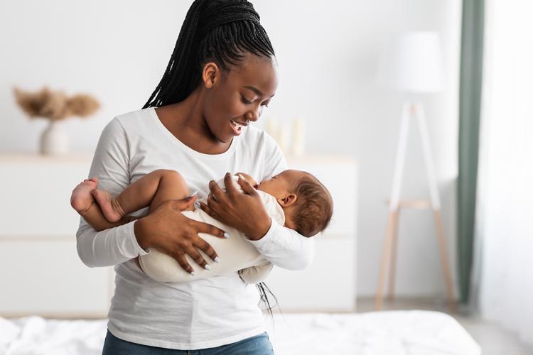 Woman holding a baby while singing