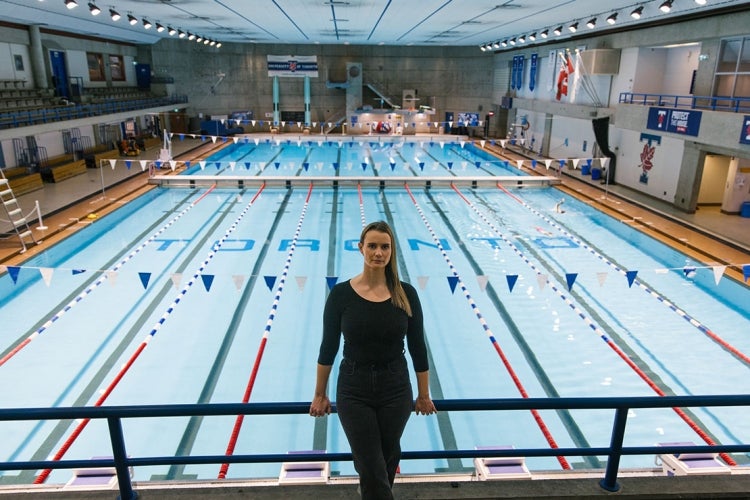 Erin Willson stands above the pool at the University of Toronto