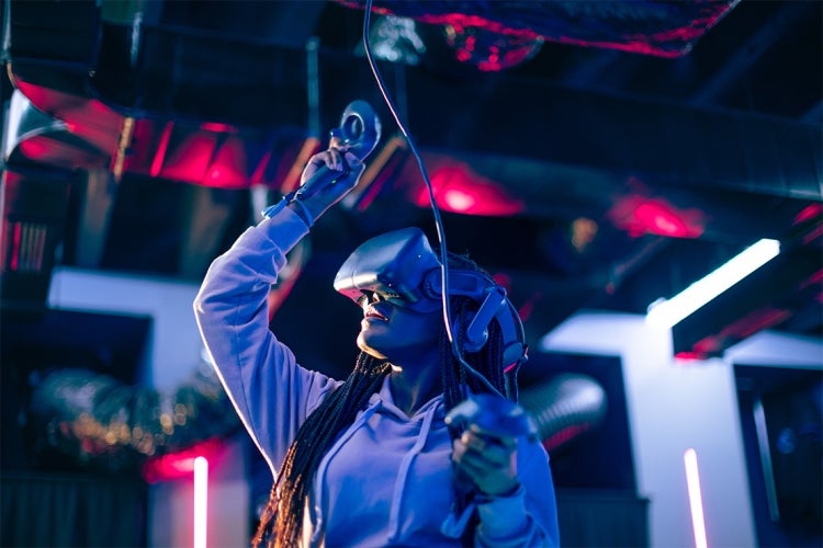 Woman uses a VR system in a darkened room