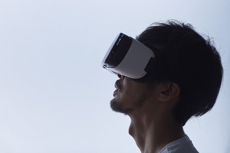 Man wearing a VR headset and looking off screen