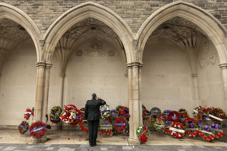 A soldier salute the wreathes laid at Soldier's Tower