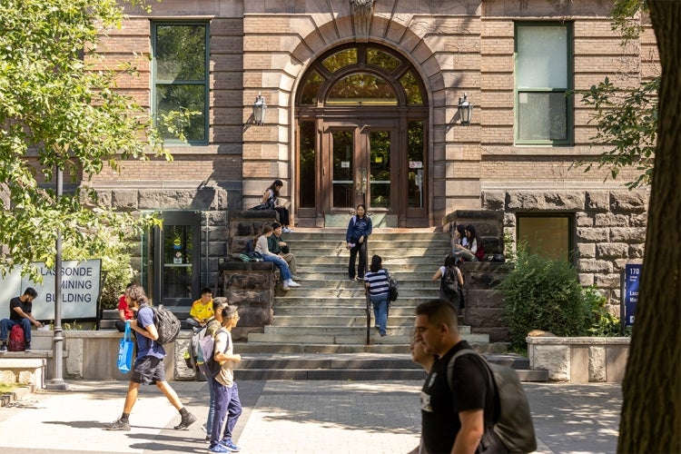 students walking in front of the Lassonde Mining Building on a warm fall day