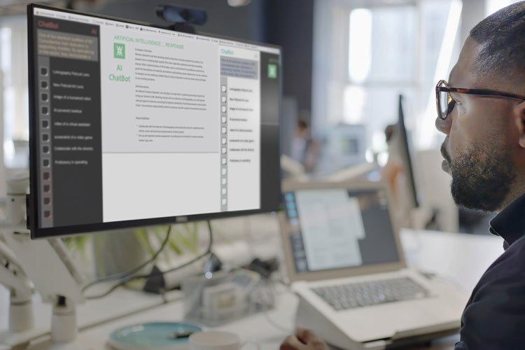 Man in a lab working on a computer that shows an AI chatbot