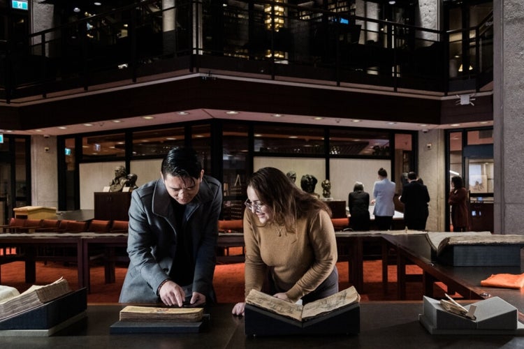 Two students examine a book in U of T's Fisher Rare Book Library