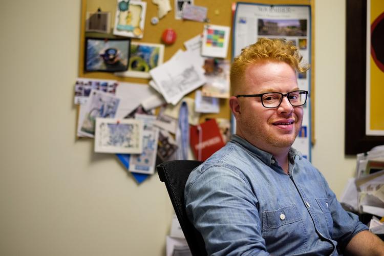 A picture of David Roberts, assistant professor of urban studies, in his office