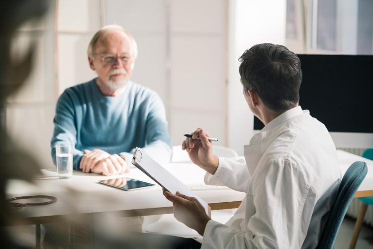 a doctor consults with a senior citizen patient