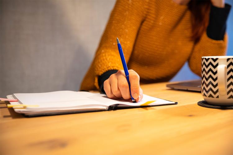 young adult woman looks stressed while studying