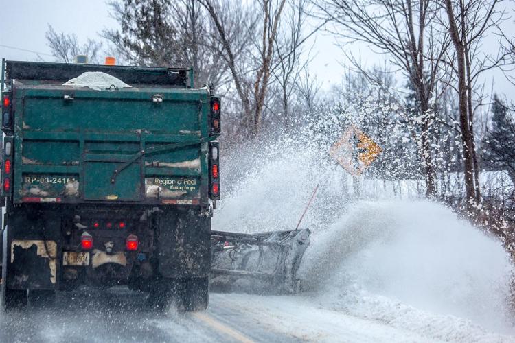 Snowplow plowing snow on a Peel Region street