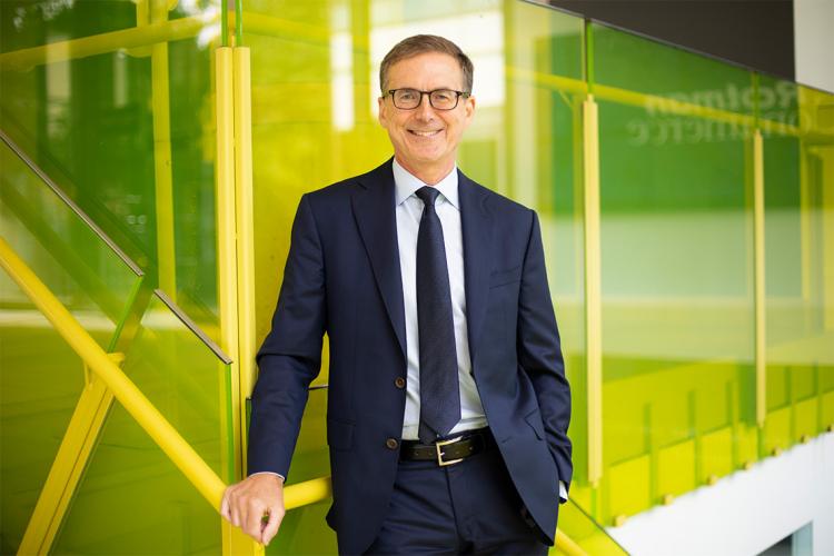 Tiff Macklem stands in front of a yellow staircase