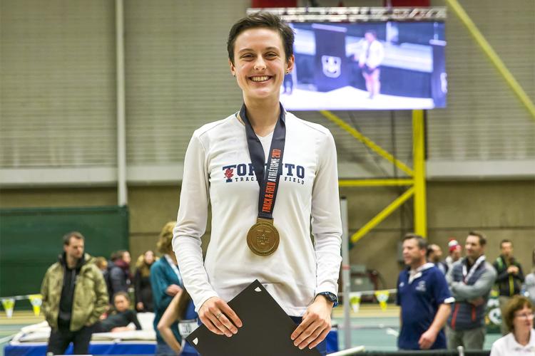 Gabriela DeBues-Stafford stands with a medal draped around her neck