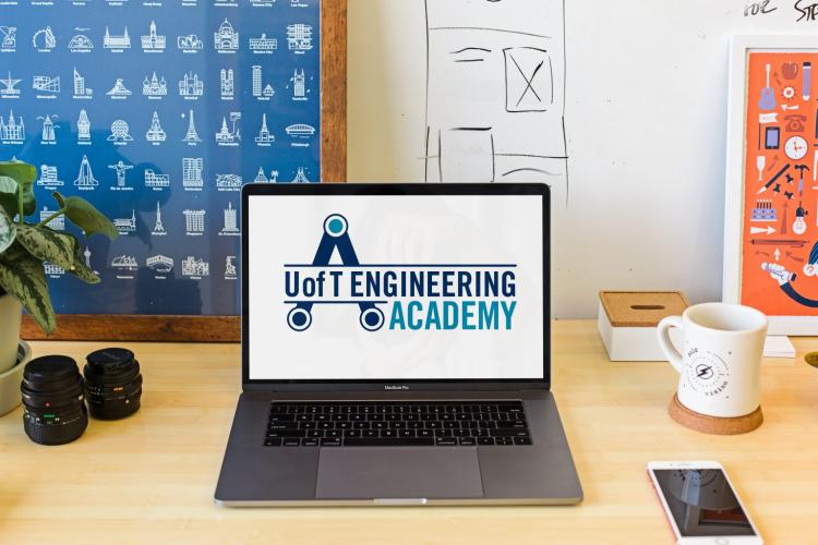 A laptop sitting on a desk with the U of T Engineering Academy landing page displayed on the screen