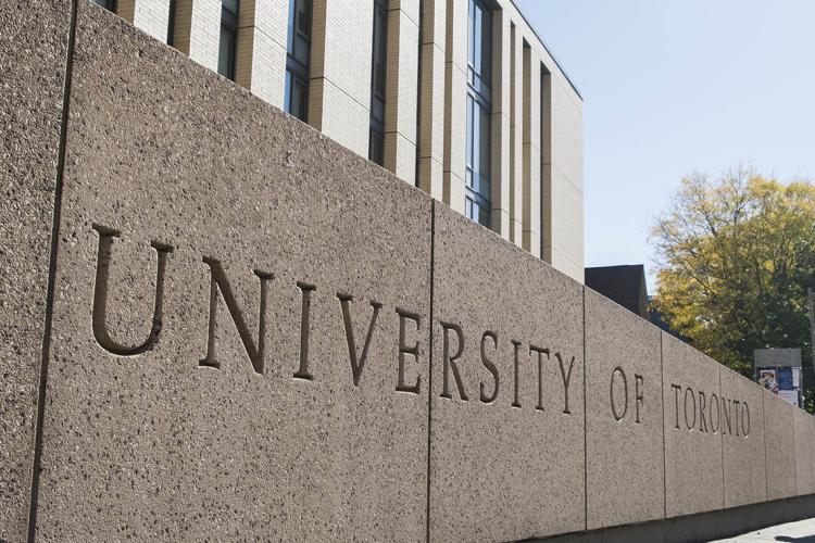 A photo of a stone planter on the St. George campus with the University of Toronto etched into its side