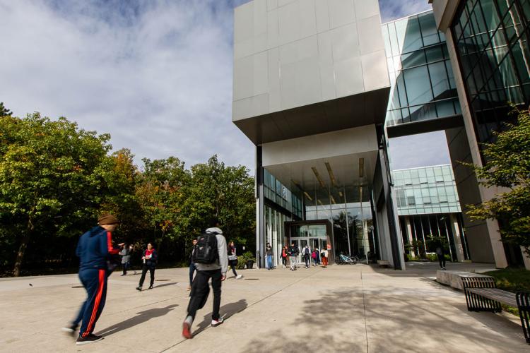 Students walking outside at the UTM campus on a sunny fall day