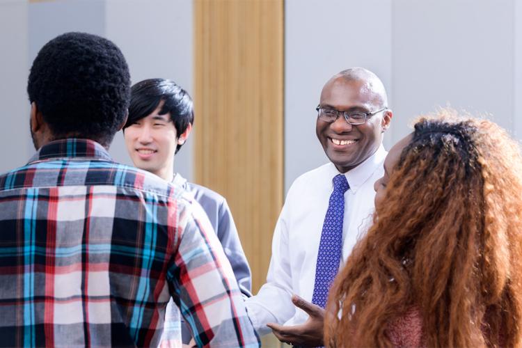 Wisdom Tettey laughs and speaks to students