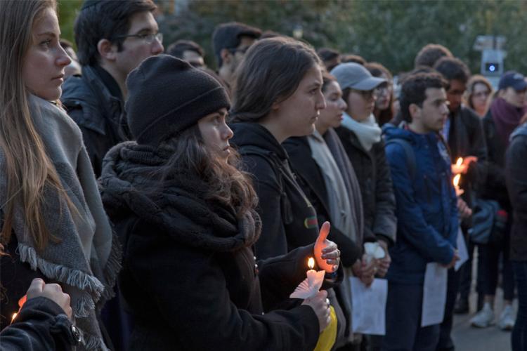 Photo of vigil attendees holding candles