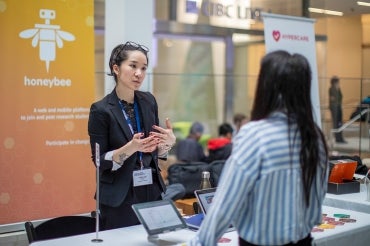 Catherine Chan speaks to an attendee of the true blue expo at the Mars discovery district