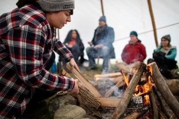 Photo of students building fire during course