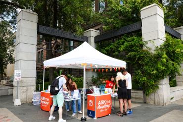 AskMe volunteers help students outside the King's College Road gate at the St. George campus of U of T