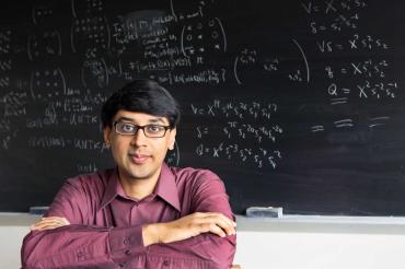 photo of Bhargava in front of blackboard