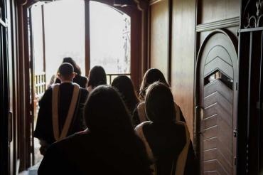 photo of grads exiting university college doors