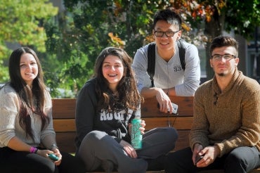 Photo of four students on bench