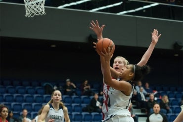 Photo of women playing basketball