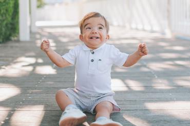 a delighted baby sitting outside