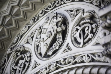 U of T coat of arms carved in to University College arch