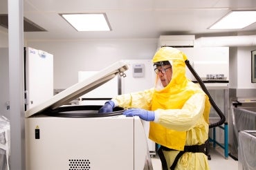 man working a Toronto High Containment Facility in a hazmat suit